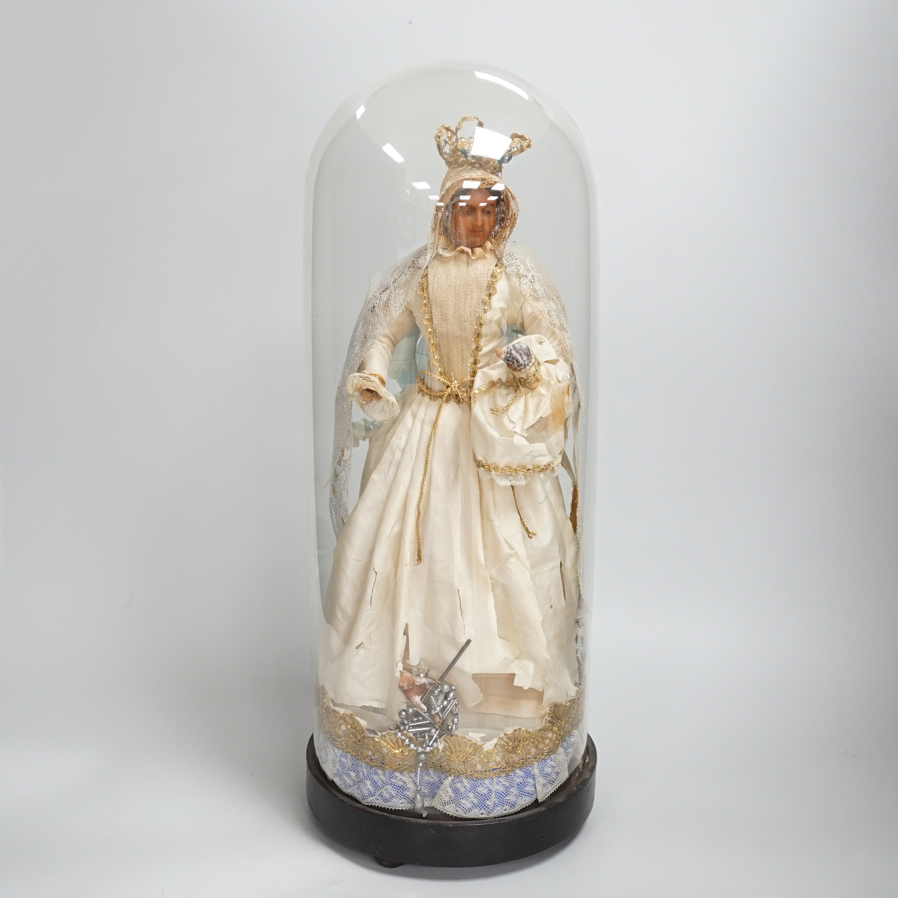 A waxed dressed figure with crown holding a baby under a glass dome 49.5cm high